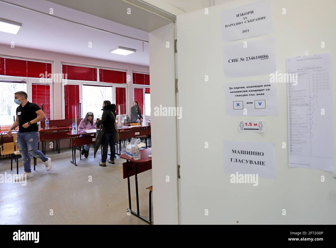 People with masks are voting during coronavirus pandemic for Bulgarian parliamentary elections and for the first time in history with paper and machin Stock Photo