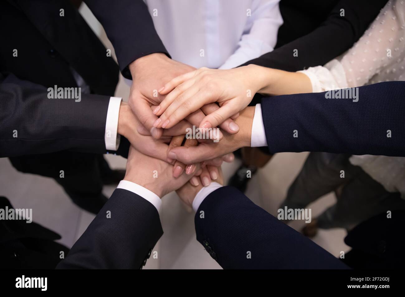 Close up of diverse employees stack hands Stock Photo - Alamy