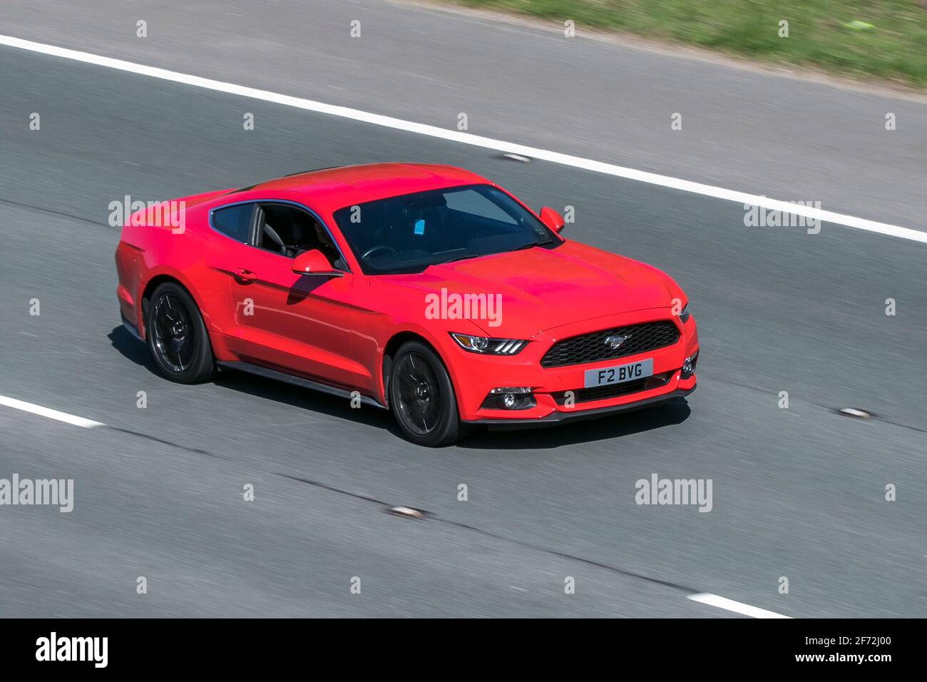 2016 red Ford Mustang Ecoboost;  moving vehicles, cars, vehicle driving on UK roads, motors, motoring on the M6 English motorway road network Stock Photo