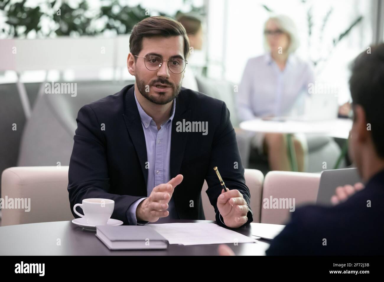 Young businessman talk with client at office meeting Stock Photo - Alamy