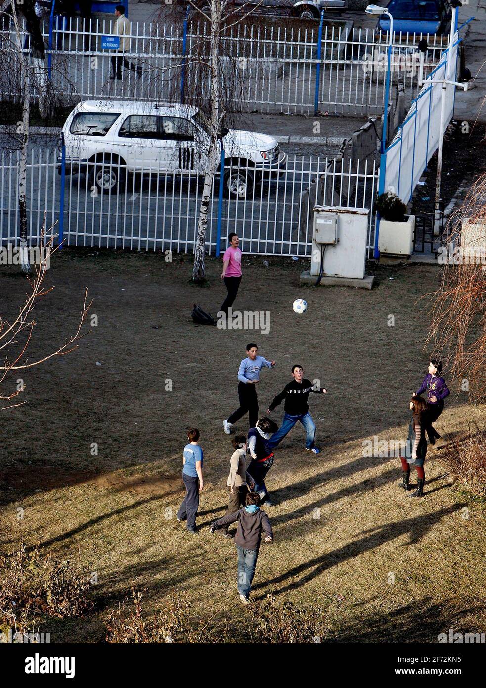 Children playing football in the UN backyard in Kosovo's capital Pristina. Stock Photo