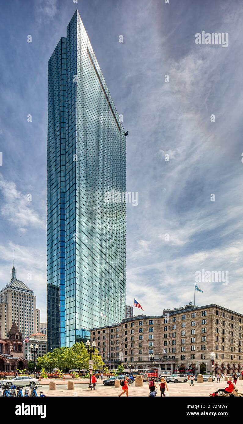200 Clarendon Street, aka John Hancock Tower, reflects the sky and everything around it in the famous blue glass panels. Stock Photo