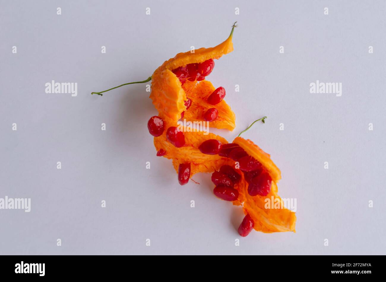 Open Red Pulp Cerasee Fruits On White Background Stock Photo Alamy