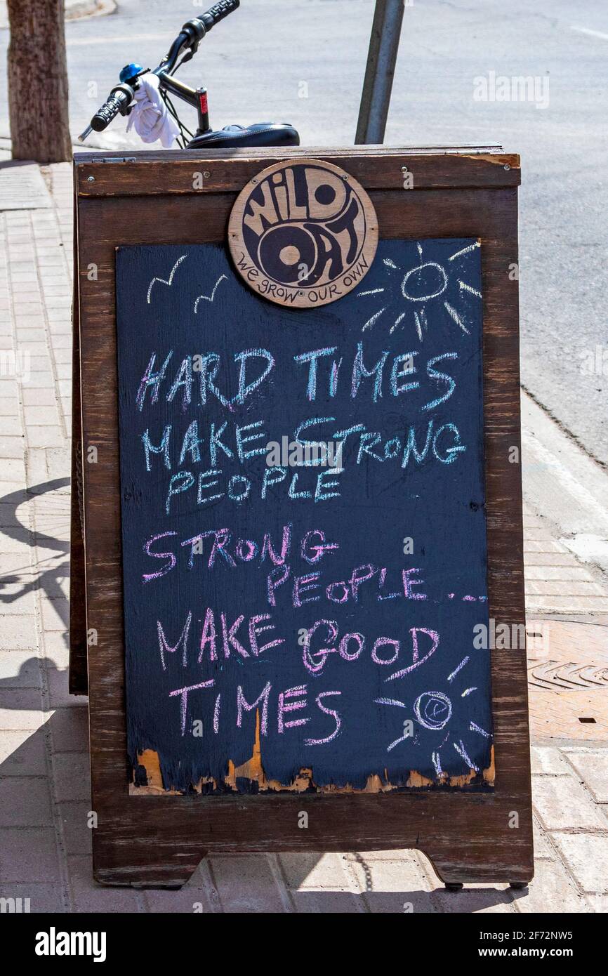 Sidewalk chalkboard with inspirational message with hope of better times post-pandemic - Hard times make strong people. Strong people make good times. Stock Photo