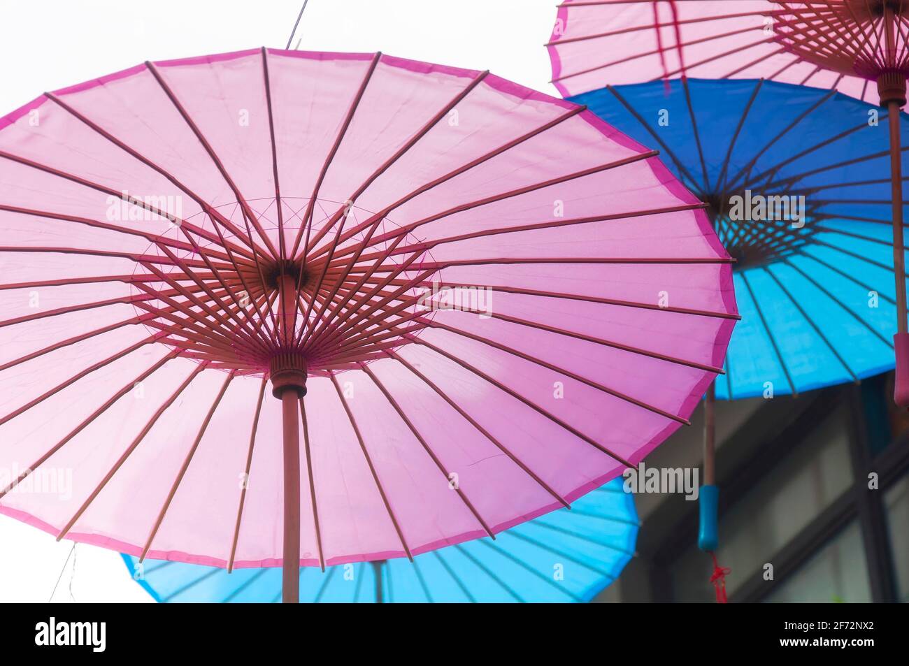 Chinese oil paper umbrellas hanging above the narrow alleyways of tianzifang on the puxi side of shanghai china. Stock Photo