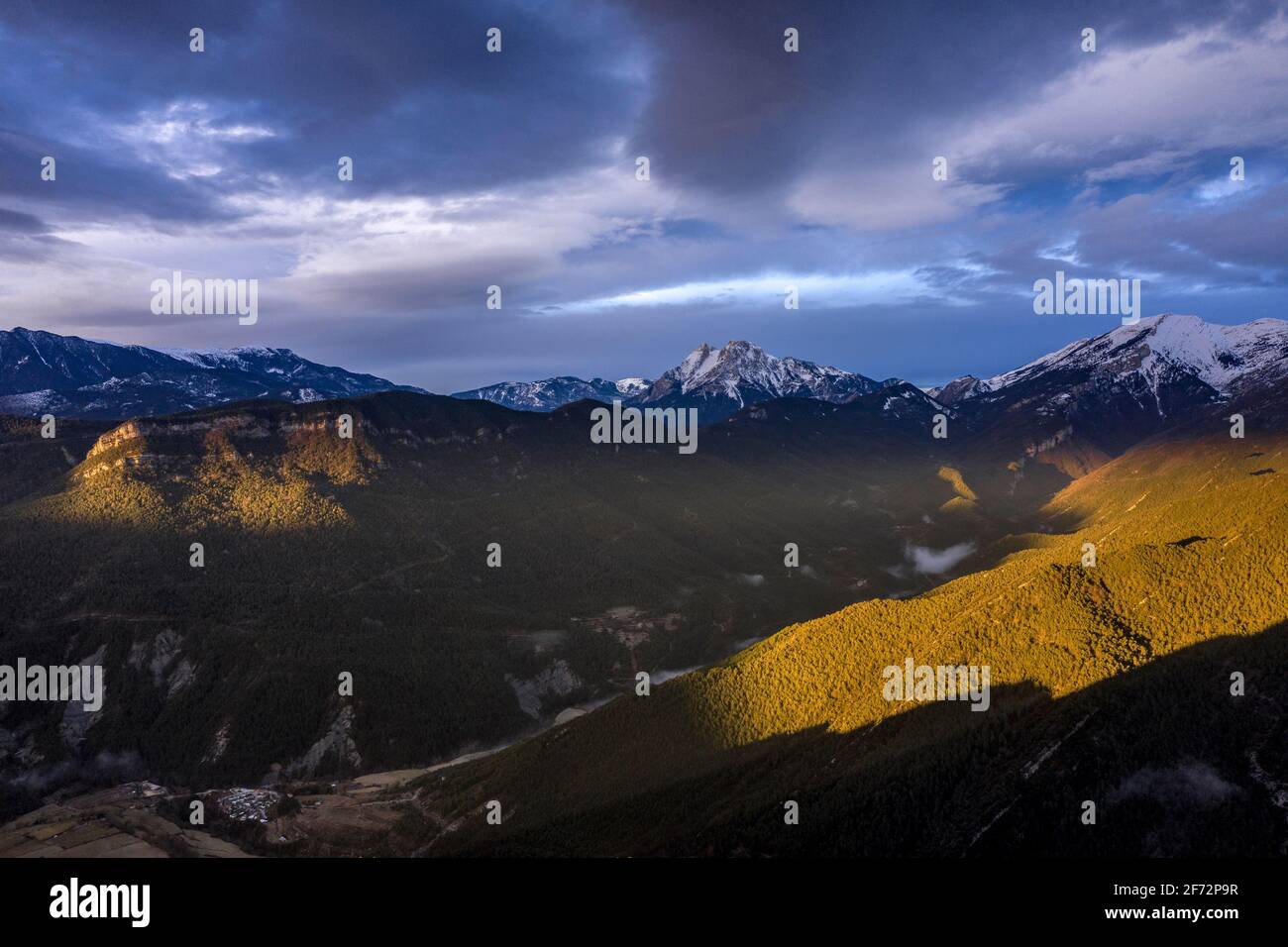 Pedraforca and Alt Berguedà aerial view in a winter cloudy sunrise with a golden light (Barcelona province, Catalonia, Spain, Pyrenees) Stock Photo