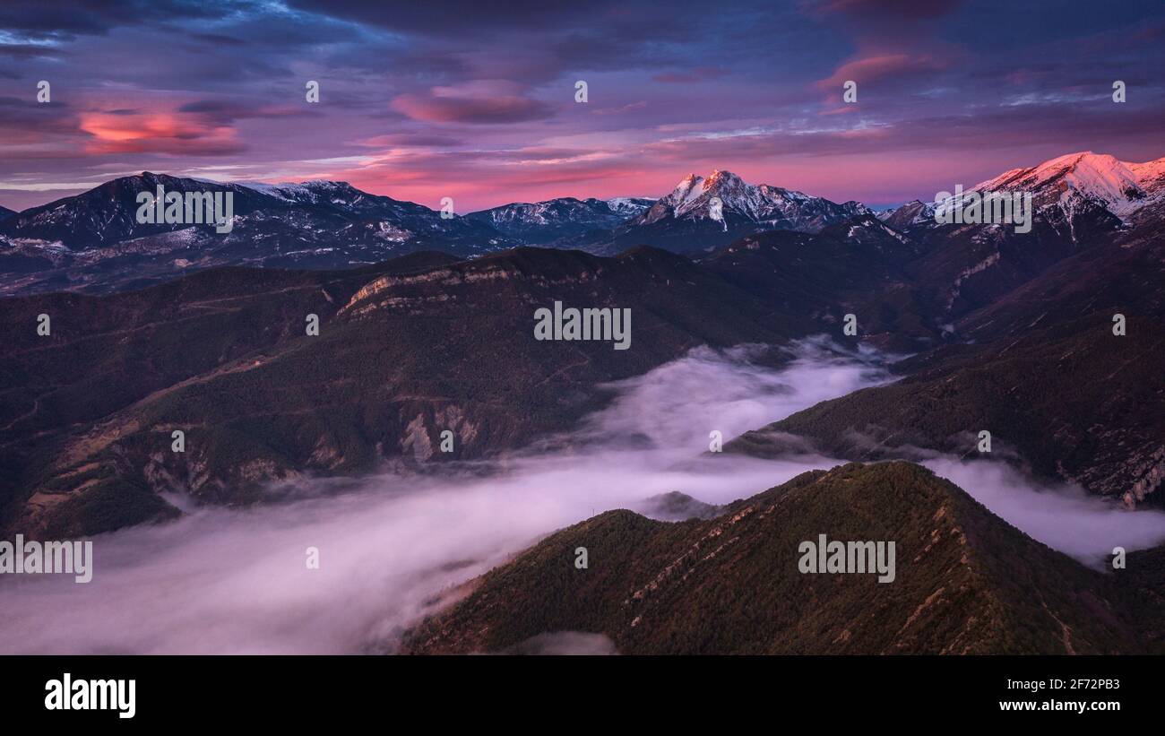 Pedraforca and Alt Berguedà aerial view in a winter red sunrise with a sea of clouds (Barcelona province, Catalonia, Spain, Pyrenees) Stock Photo