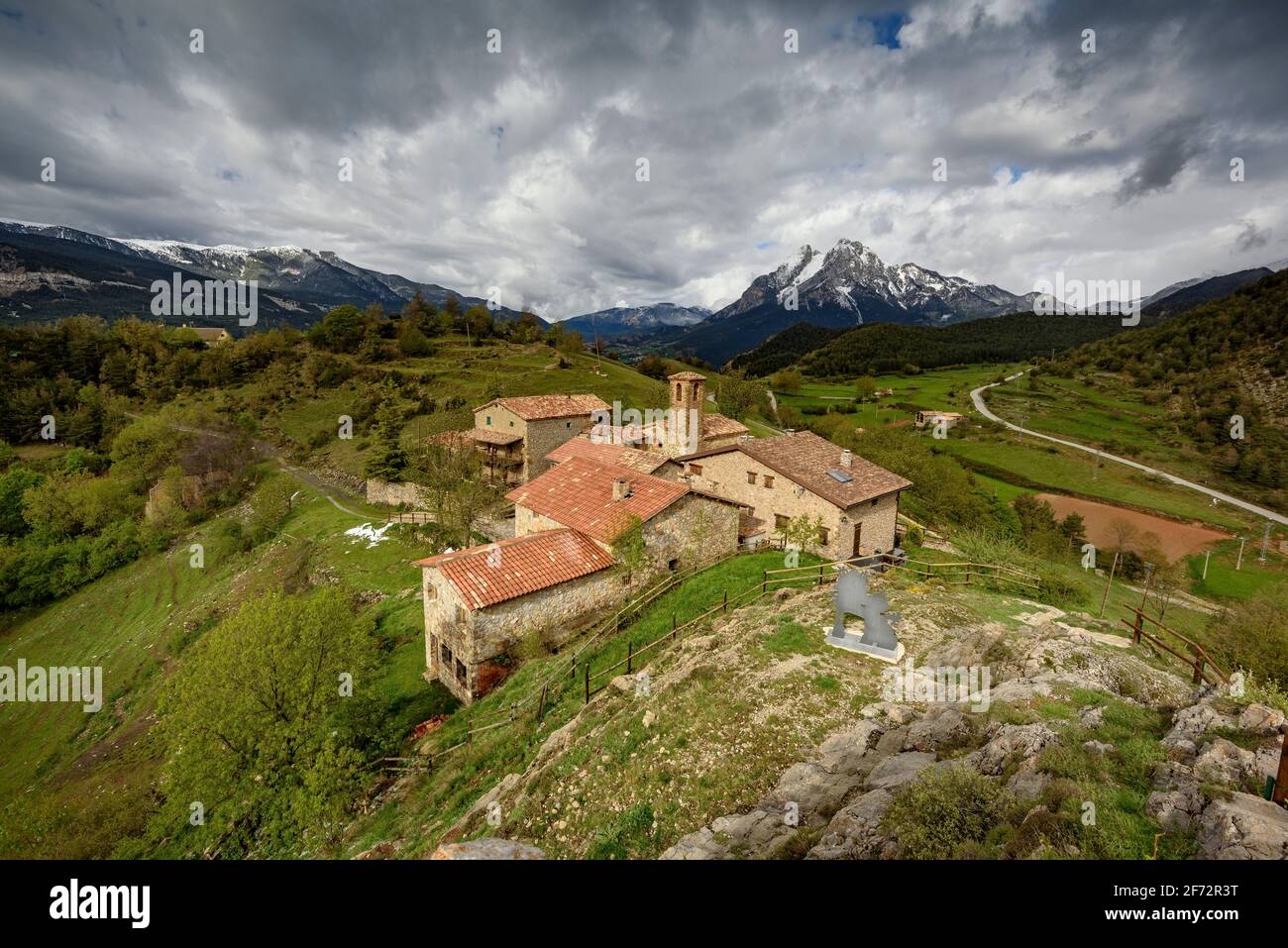 Pedraforca mountain and Gisclareny village seen from the Gargallosa viewpoint, in a cloudy spring morning (Barcelona province, Catalonia, Spain) Stock Photo