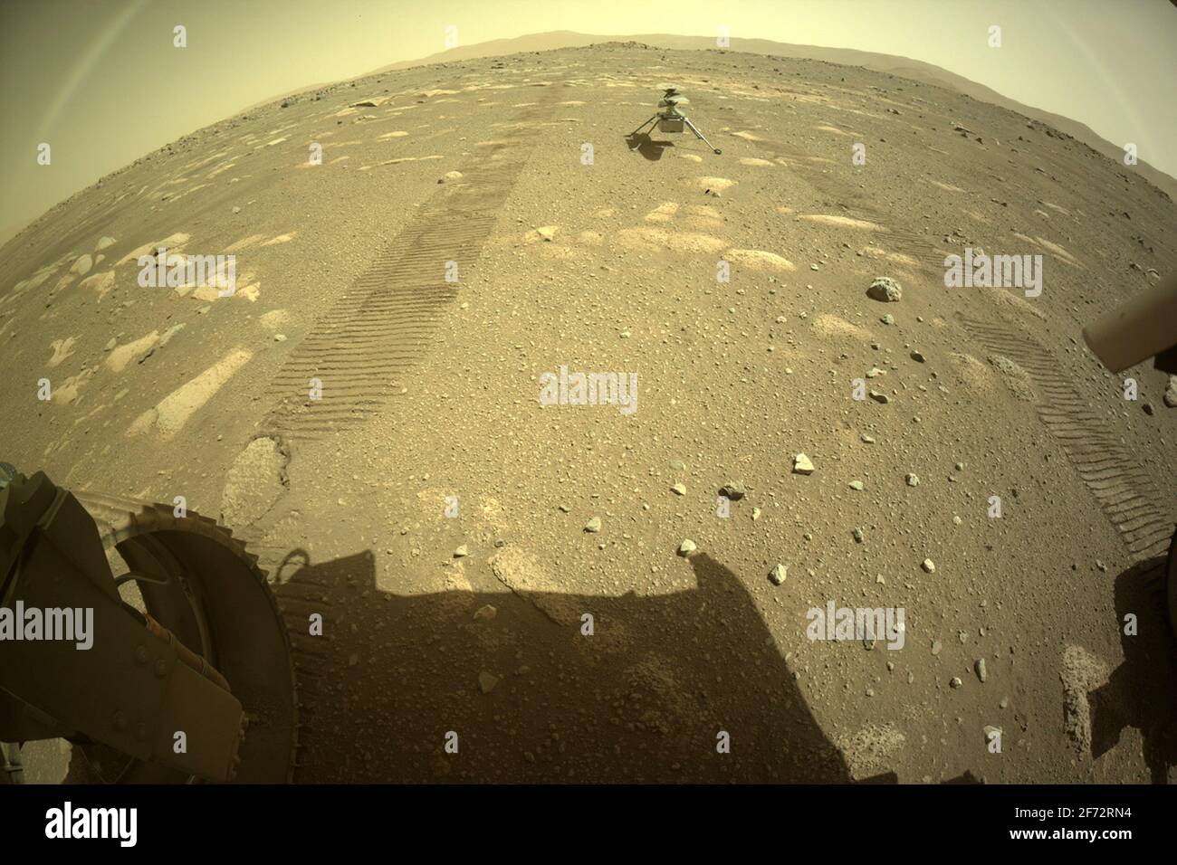 Washington, United States. 04th Apr, 2021. NASA's Mars Perseverance rover acquired this image of the Ingenuity Mars Helicopter using its onboard Rear Left Hazard Avoidance Camera on April 4, 2021 (Sol 43). NASA is targeting no earlier than April 8 for the Ingenuity Mars Helicopter to make the first attempt at a powered, controlled flight of an aircraft on another planet. NASA/UPI Credit: UPI/Alamy Live News Stock Photo