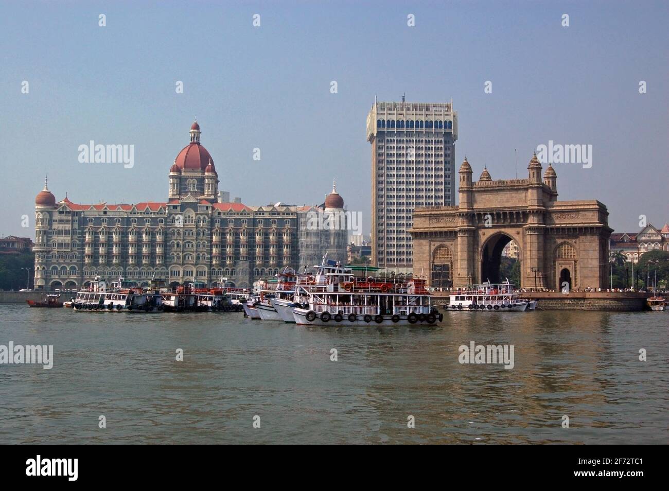 A view of the magnificent Gateway to India beside the Taj hotel and Tower hotel viewed from the harbour at Mumbai (formerly Bombay). Stock Photo