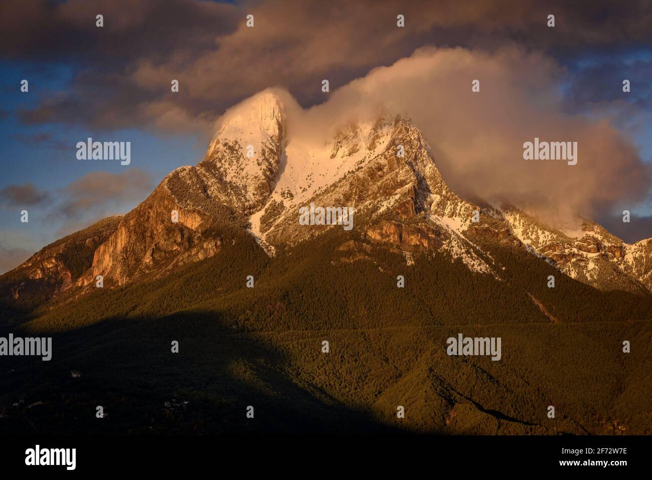 Winter cloudy sunrise at Pedraforca after a snowfall, viewed from Maçaners (Barcelona province, Catalonia, Spain, Pyrenees) Stock Photo