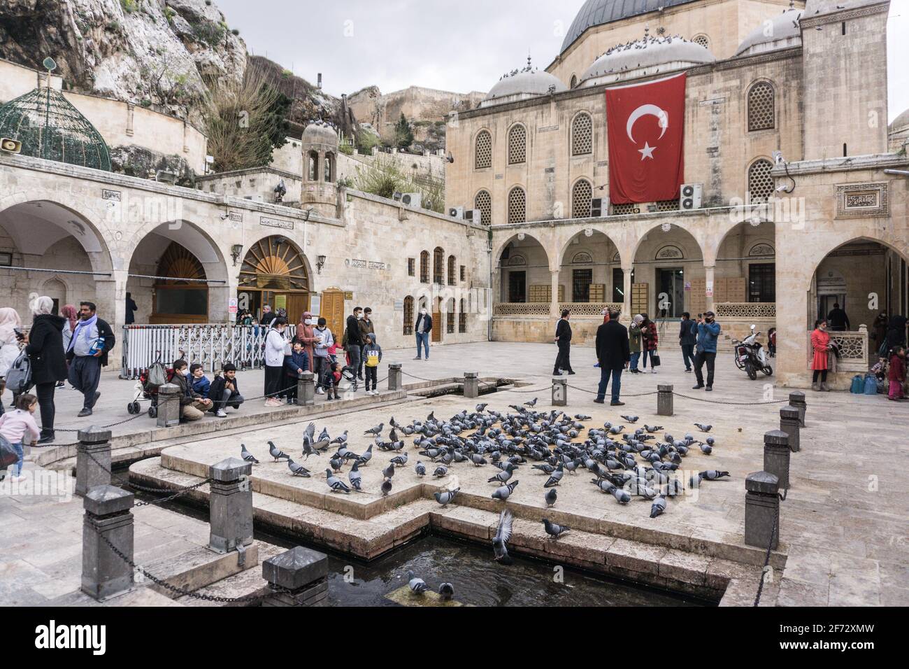 People seen feeding birds at the Mevlid-i Halil Mosque in ?anl?urfa. Stock Photo