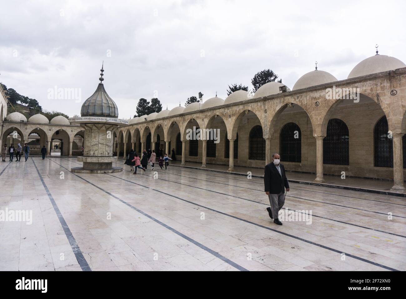 A man walks around the courtyard of Mevlid-i Halil Mosque, ?anl?urfa. Stock Photo