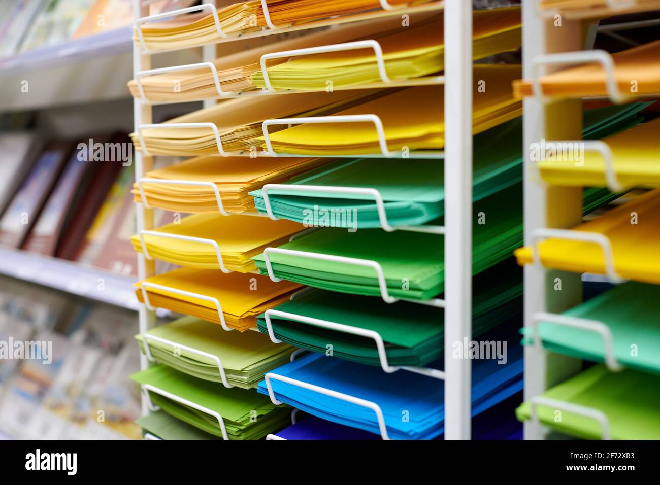 Colorful art papers on shelf display in stationery store, close up