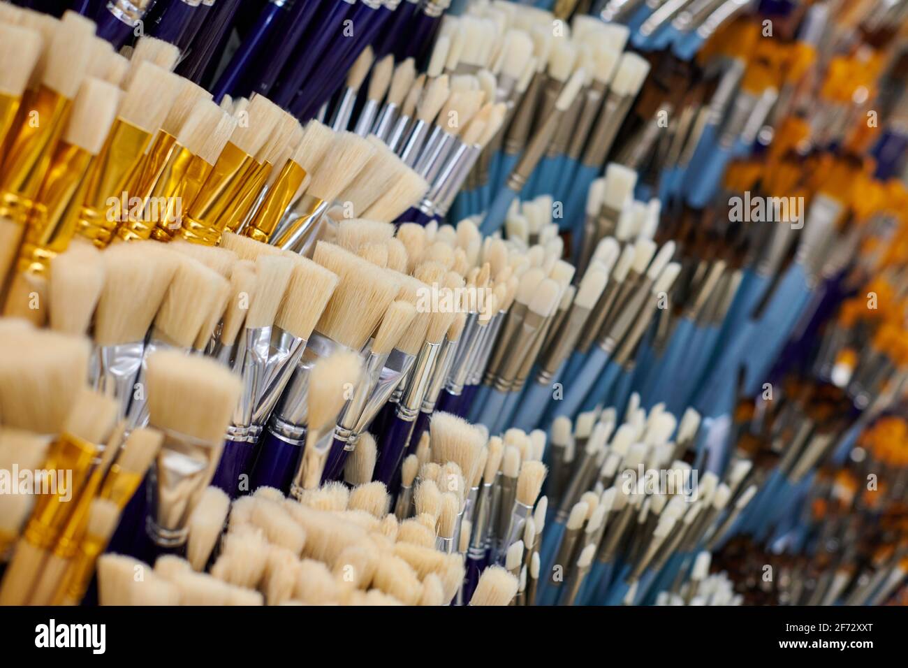 New artistic paintbrushes on shelf display in stationery shop, close up ...
