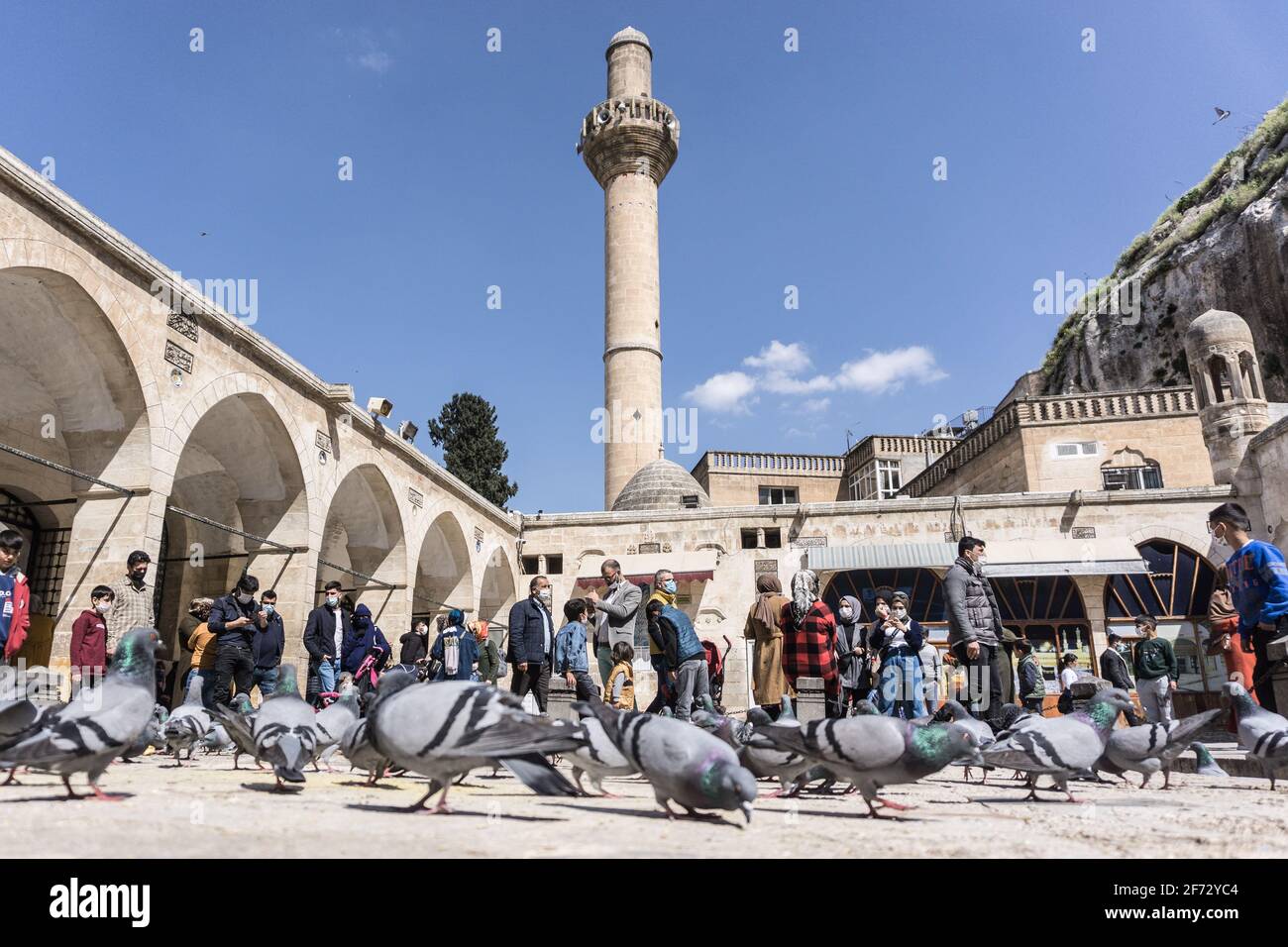 People seen feeding birds at the Mevlid-i Halil Mosque in ?anl?urfa. (Photo by Ibrahim Oner/SOPA Images/Sipa USA) Credit: Sipa USA/Alamy Live News Stock Photo