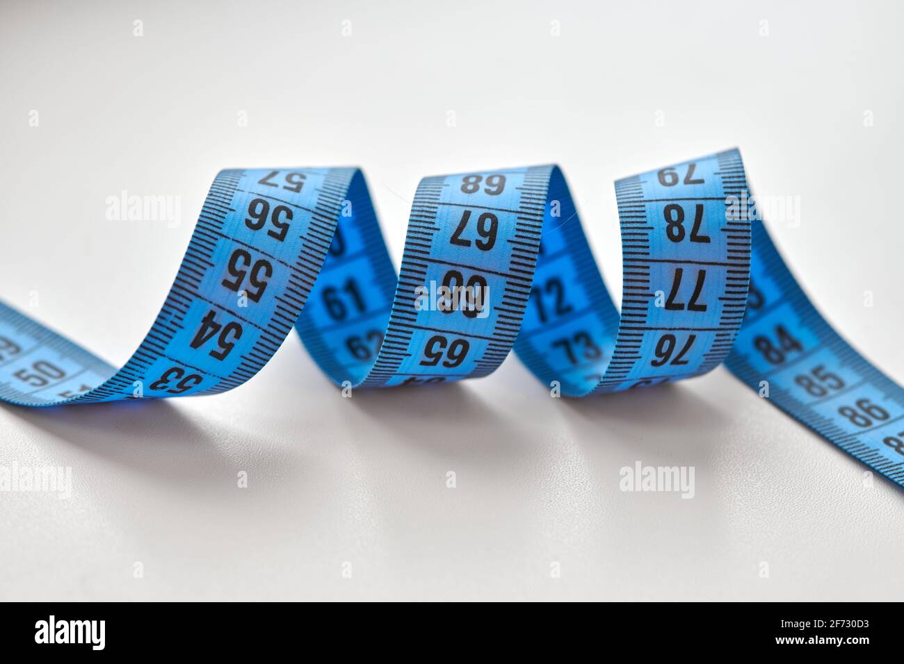 Blue measuring tape isolated on white background. Stock Photo
