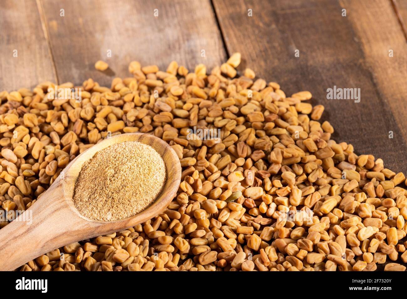 Fenugreek seeds and powder - Trigonella foenum - graecum Stock Photo