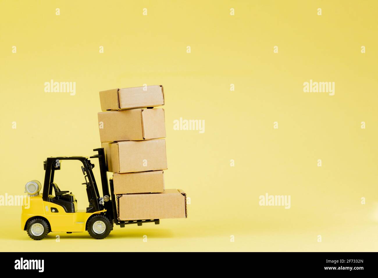 Mini forklift truck load cardboard boxes. Logistics and transportation ...