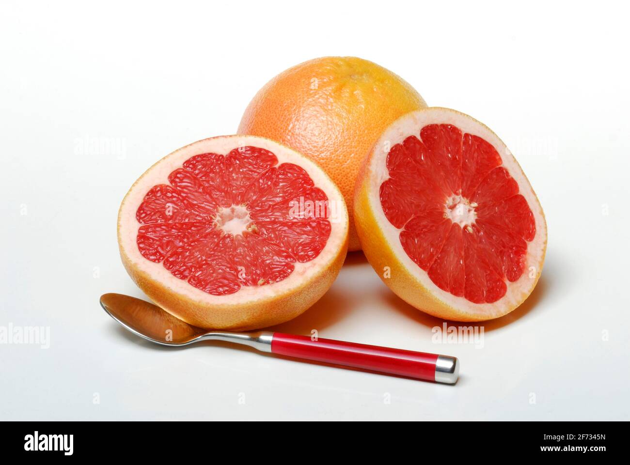 Grapefruit and spoon ( Citrus maxima, Citrus x paradisi) Stock Photo