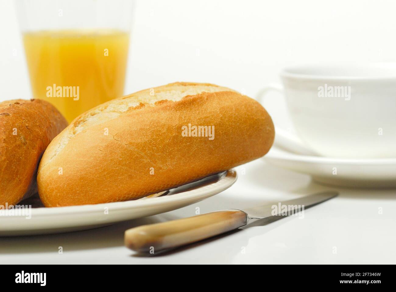 Breakfast, bread roll and orange juice, bread roll, knife Stock Photo