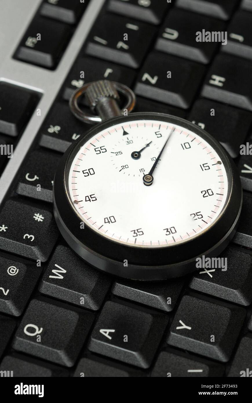 Stopwatch on computer keyboard, working time control, computer time