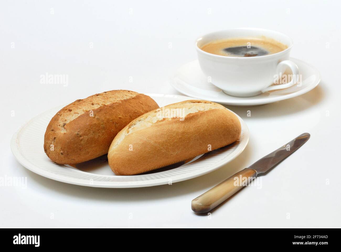Breakfast, bread roll and cup of coffee, bread roll, knife Stock Photo