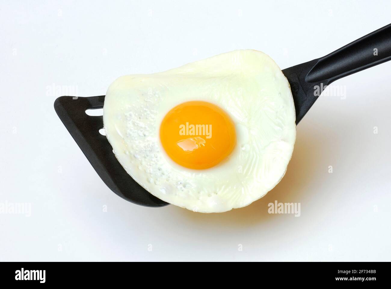 Fried egg, fried egg, spatula Stock Photo Alamy