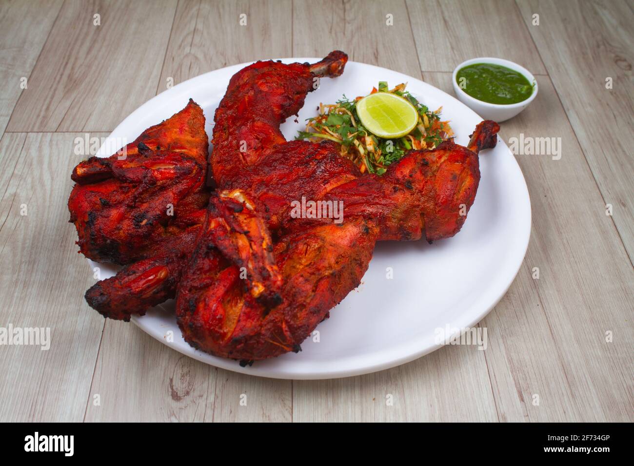Tandoori chicken is chicken dish prepared by roasting chicken marinated