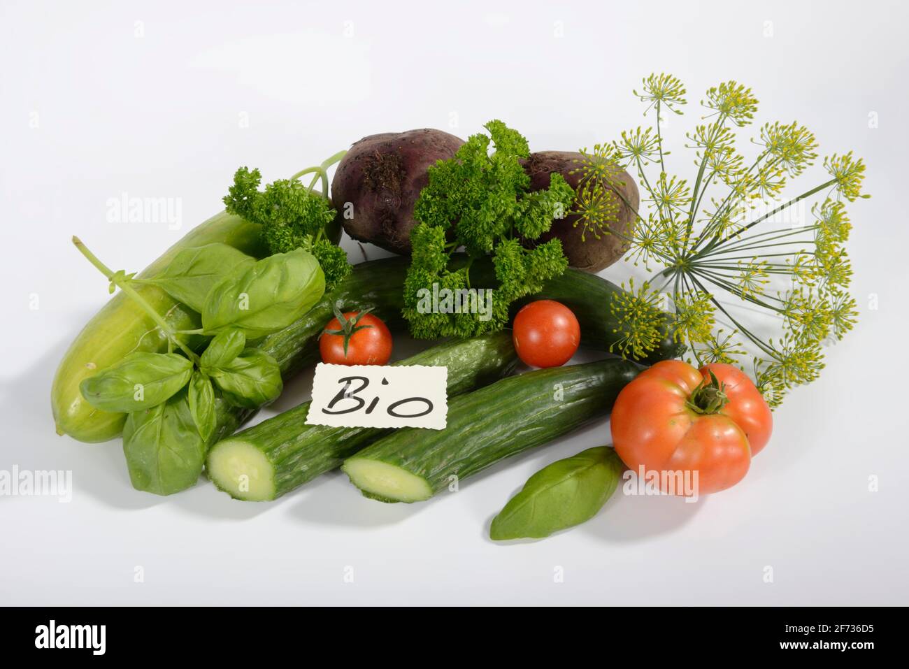 Various organic vegetables, cucumber, tomato (Solanum lycopersicum), basil (Ocimum basilicum), parsley (Petroselinum crispum), dill (Anethum Stock Photo