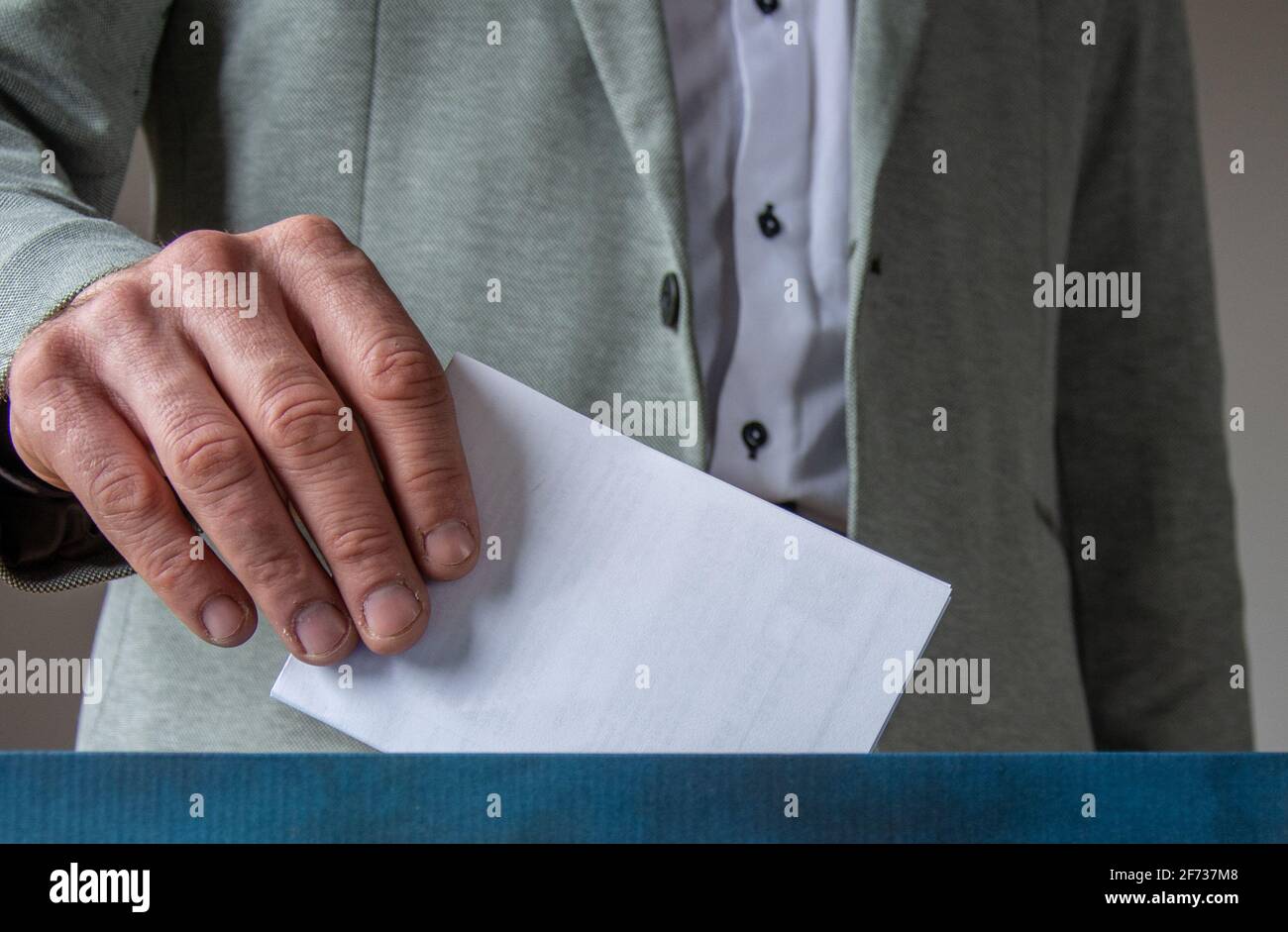 European Union parliament election concept -  hand putting ballot in blue election box Stock Photo