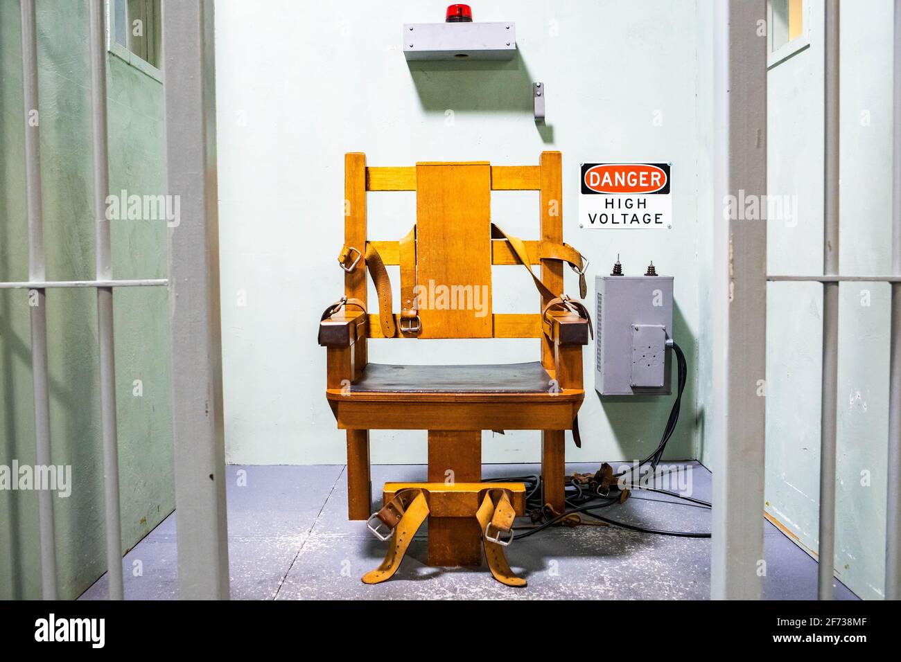 Wooden electric chair for death sentence in prison cell concept Stock
