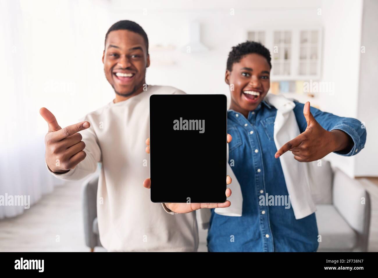 Black couple showing blank empty tablet screen for mock up Stock Photo