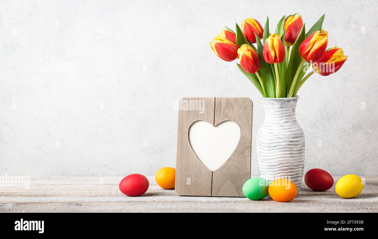 Easter background with fresh tulips and painted eggs Stock Photo - Alamy