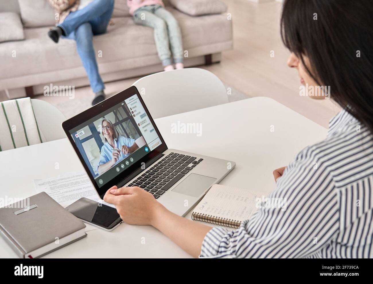 Indian woman working or learning online from home office watching webinar. Stock Photo