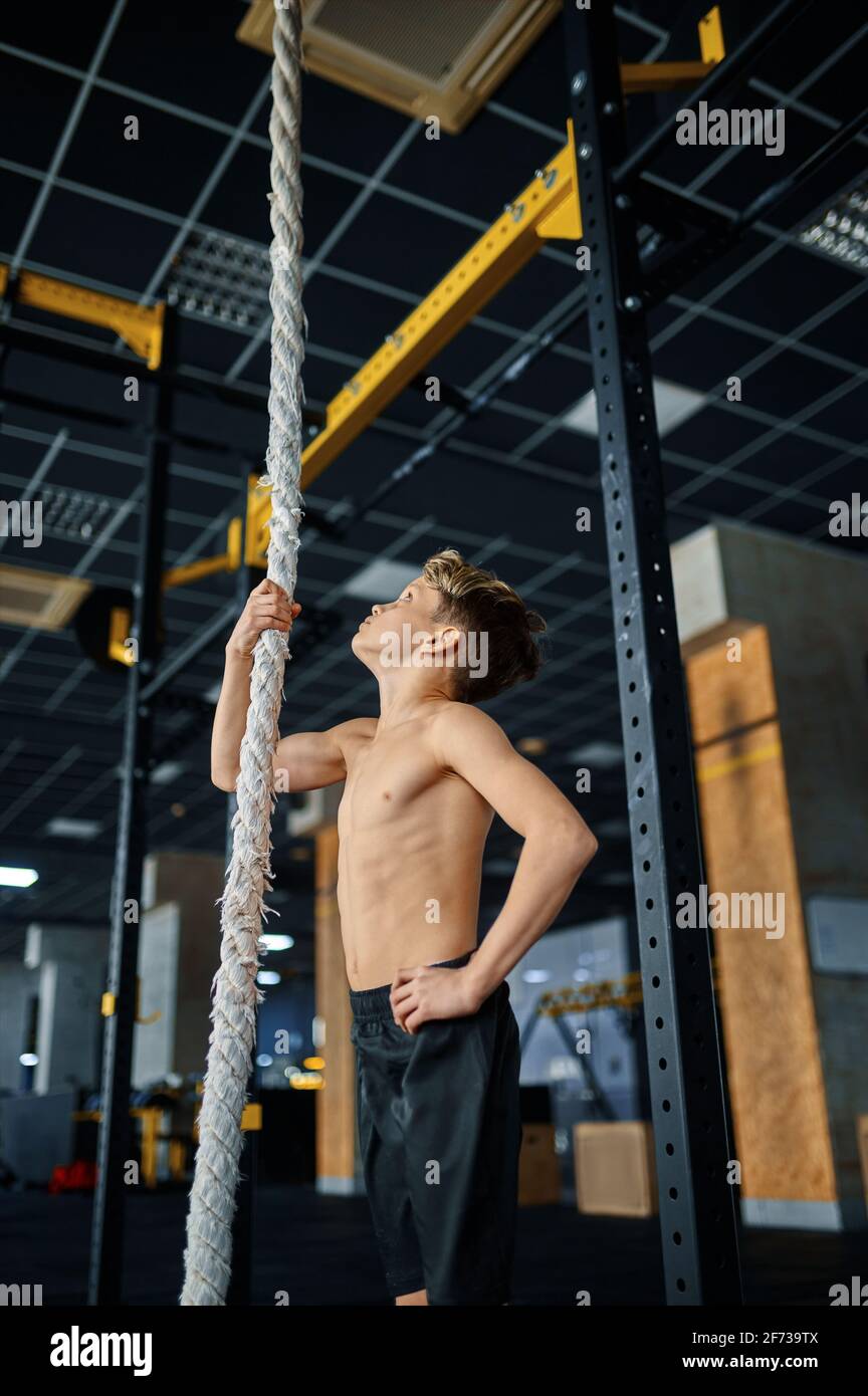 Athletic boy doing rope exercise in gym Stock Photo - Alamy