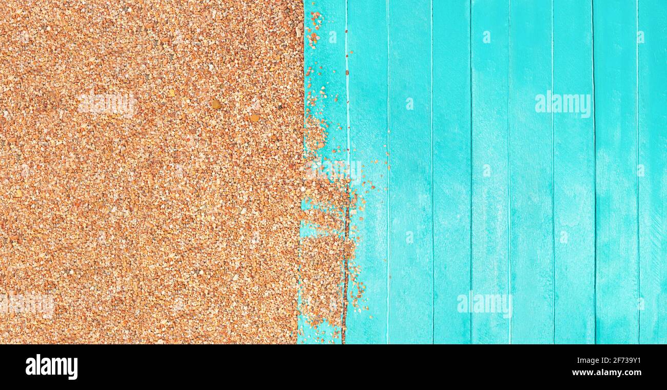 Marine banner. Turquoise wooden planks of pier with beach pebble sand. Travel and tourism. Copy space Stock Photo