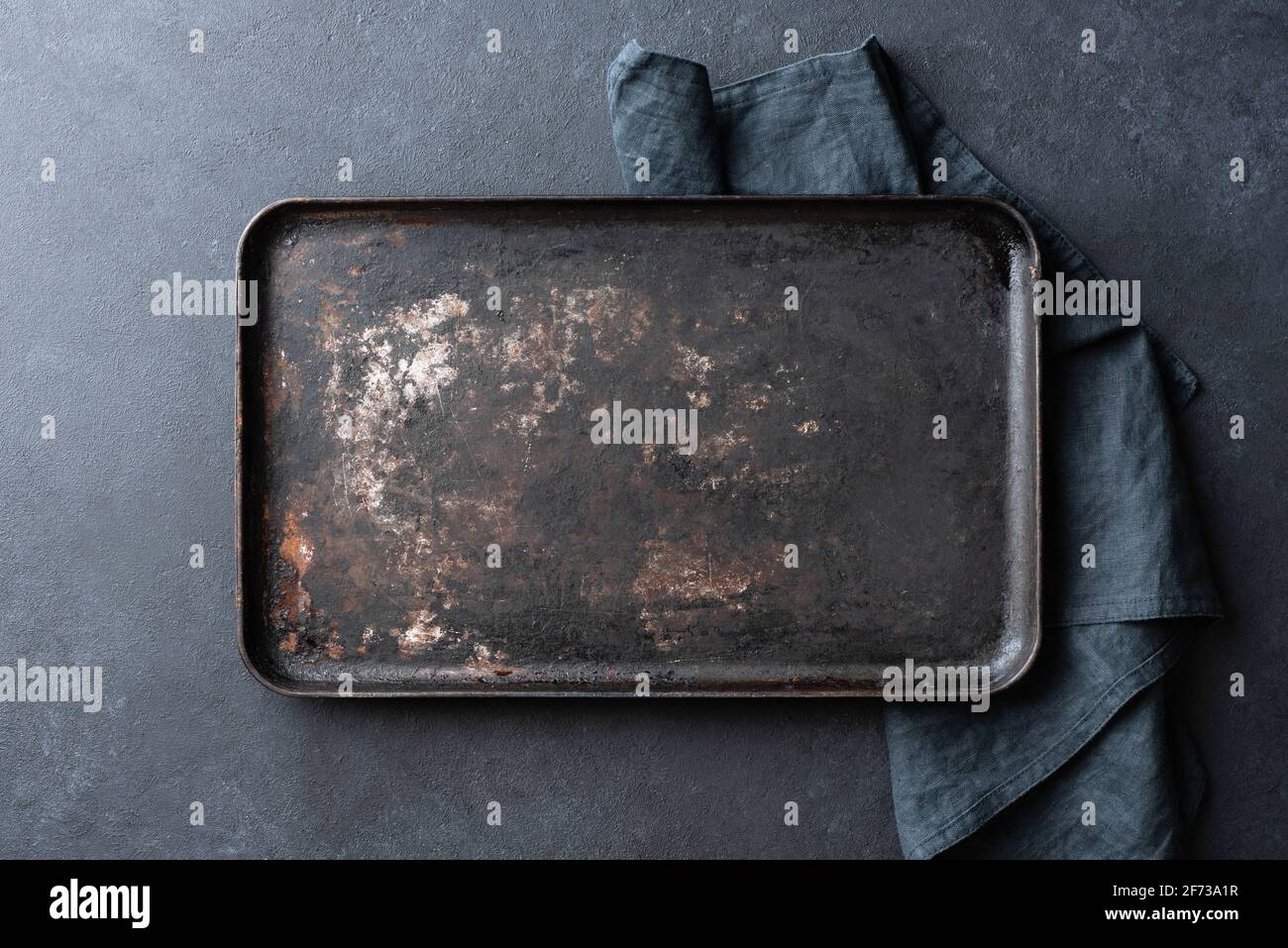 Old rusty black baking sheet background, top view, copy space Stock Photo