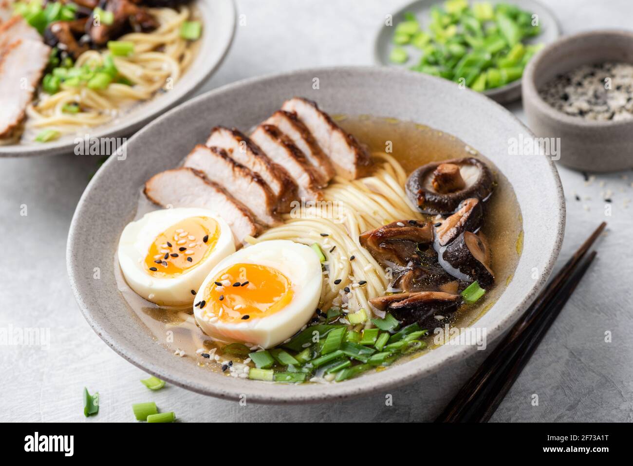 Ramen noodles with chicken, shiitake and egg in a bowl, closeup view. Asian cuisine food Stock Photo