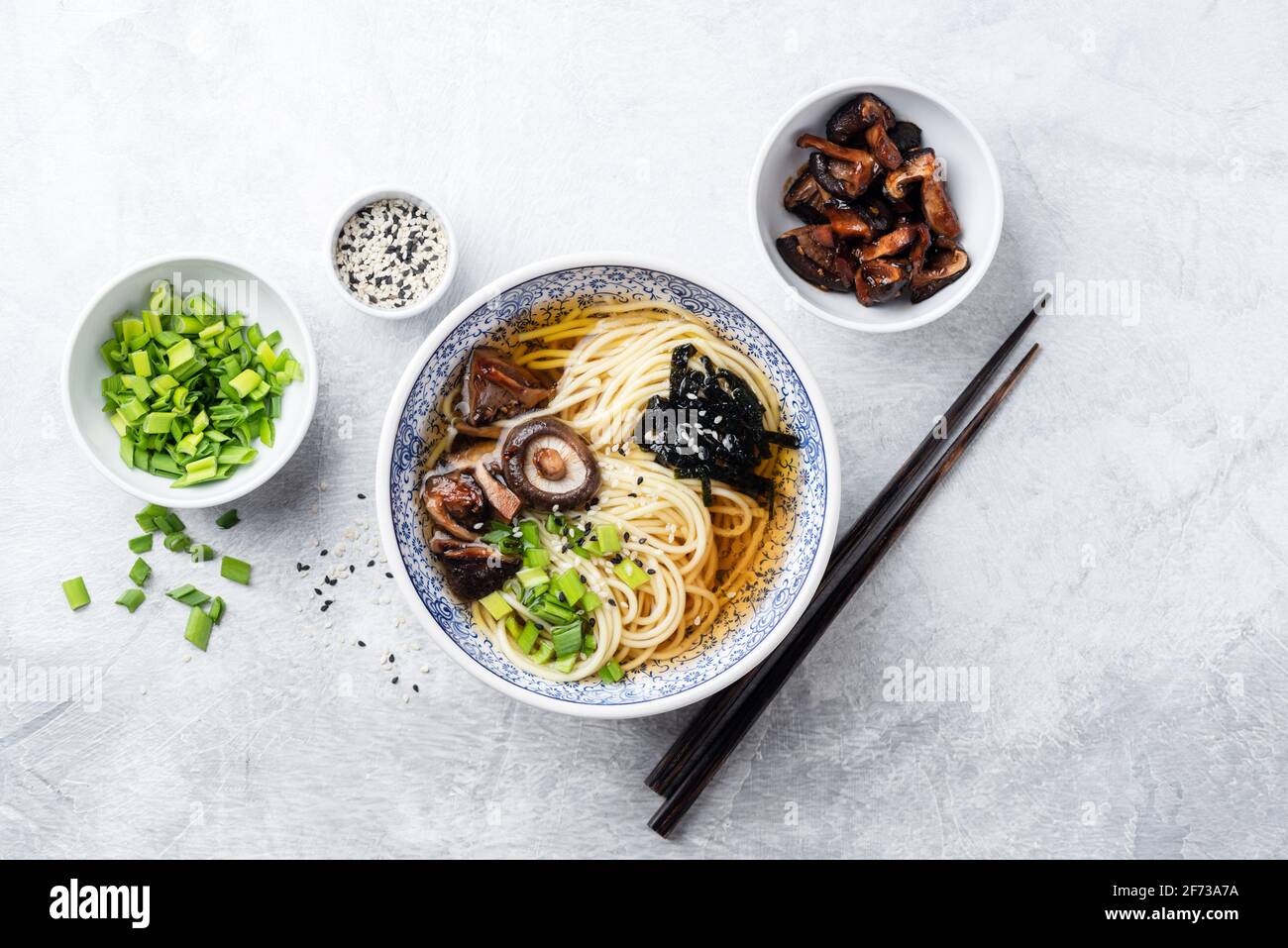 Ramen noodles with shiitake mushrooms, sea weed and spring onion. Top view Stock Photo