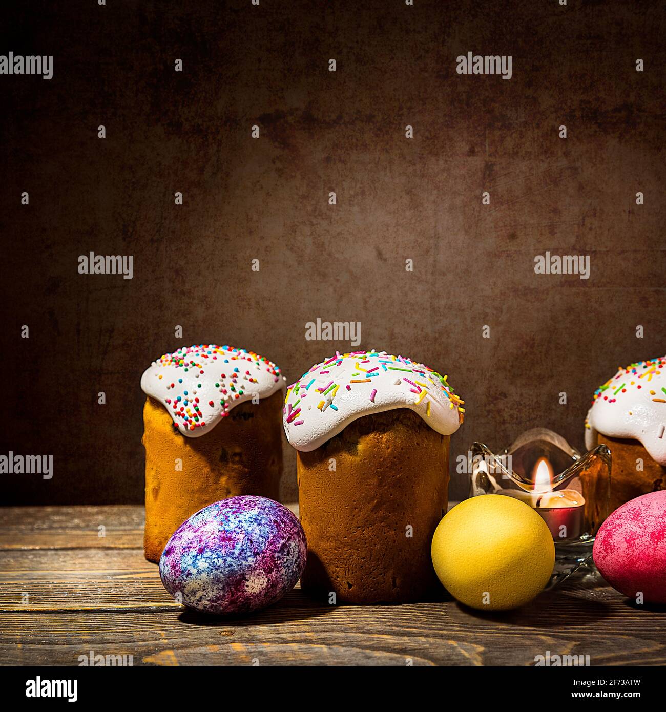 Easter cakes and Easter colored eggs on a dark background. Religious holiday of bright Easter. Stock Photo