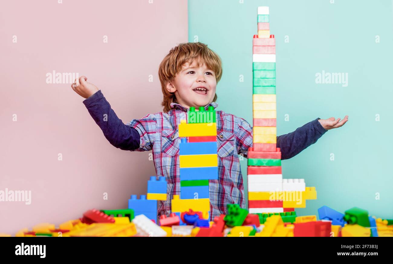 Little boy playing with lots of colorful plastic blocks constructor ...