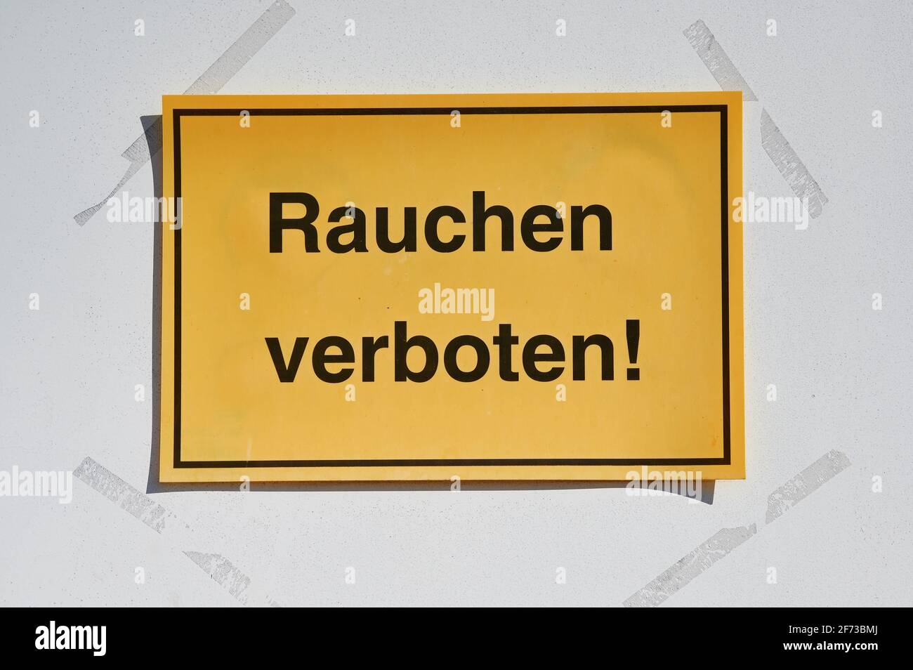 yellow sign with German text which means smoking not allowed Stock Photo