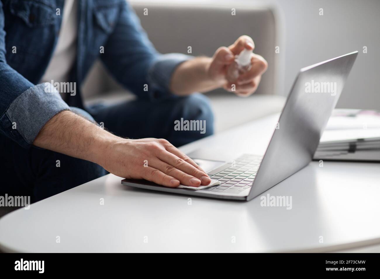 Male hands using disinfectant spray for cleaning laptop, closeup Stock ...
