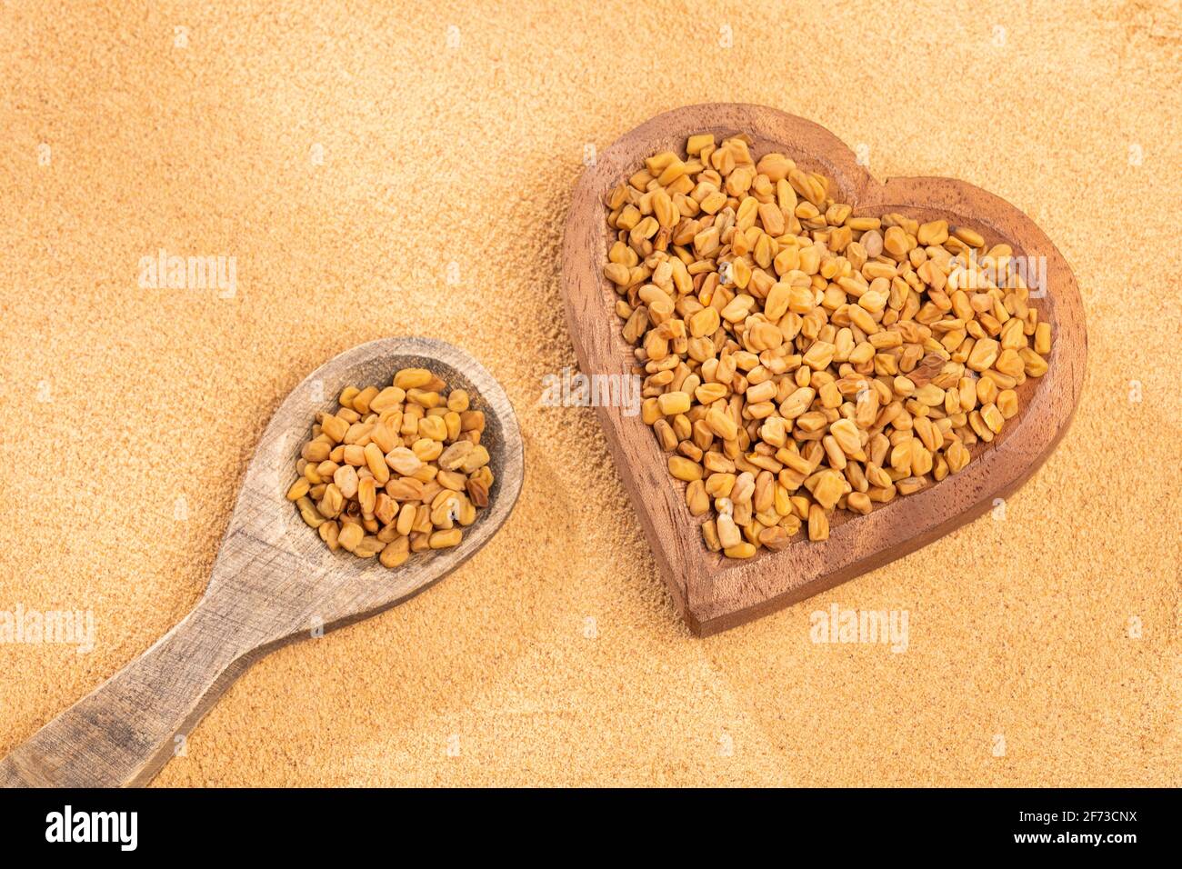 organic fenugreek seeds powder - Trigonella foenum - graecum Stock Photo