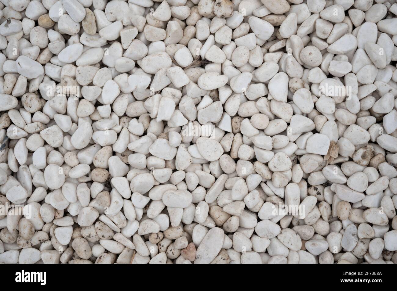 Stone pebbles - white and gray gravel texture background for decoration. Stock Photo