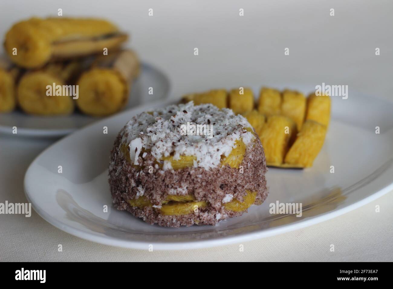Steamed finger millet flour cake with a generous layer of fresh coconut