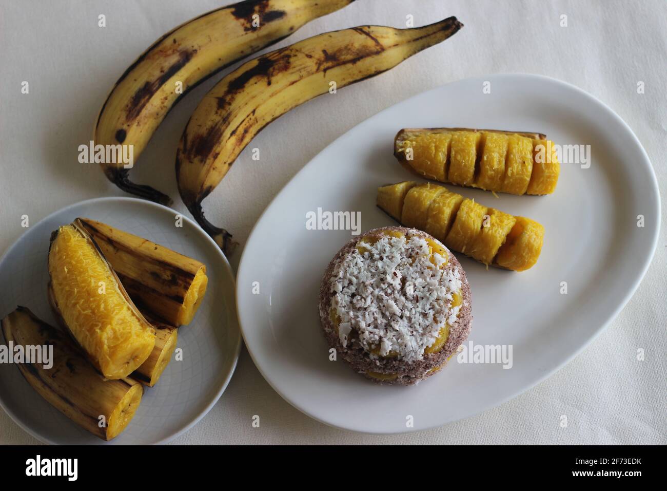 Steamed finger millet flour cake with a generous layer of fresh coconut