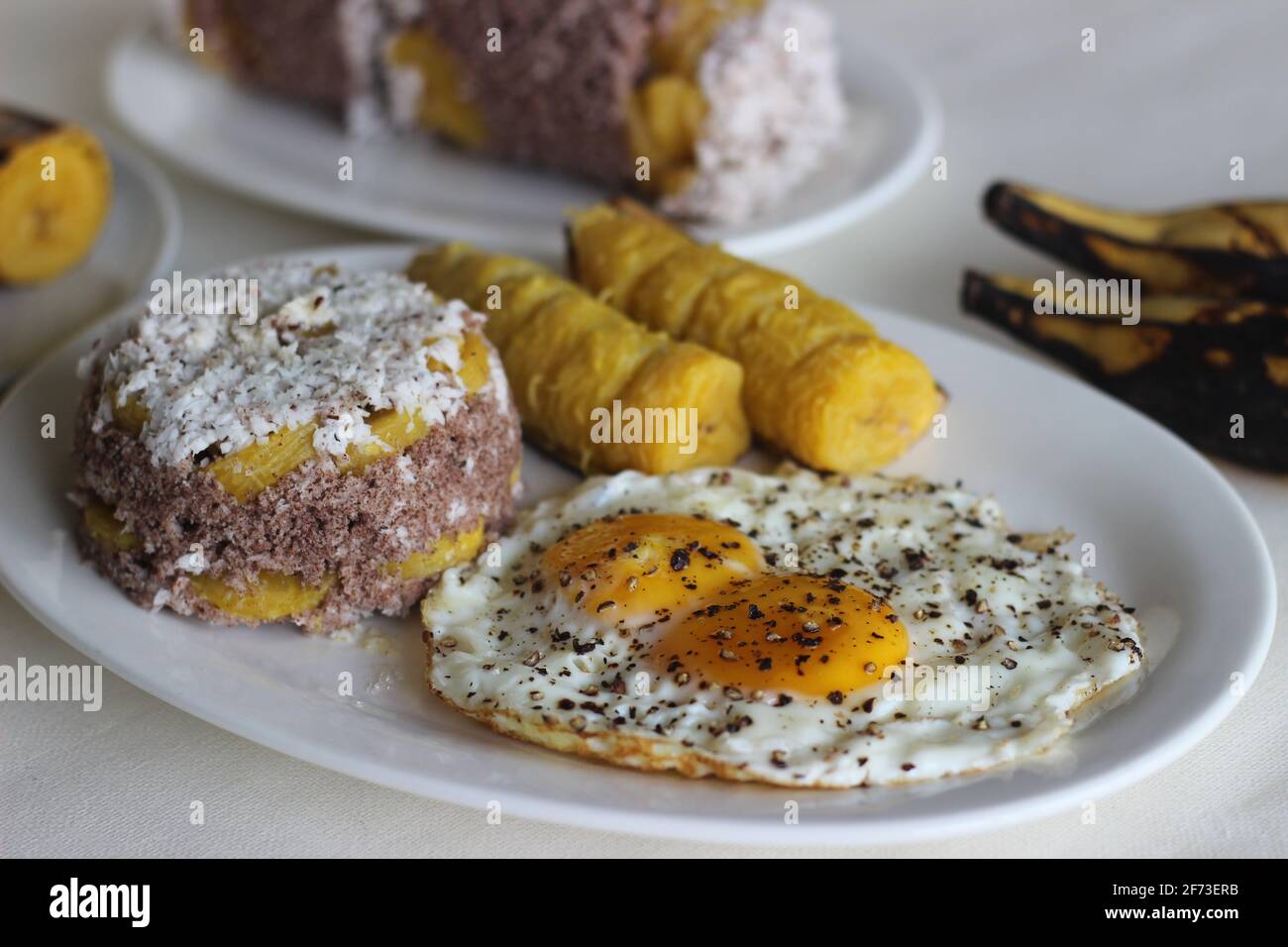 Steamed finger millet flour cake with a generous layer of fresh coconut