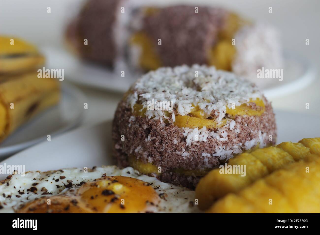 Steamed finger millet flour cake with a generous layer of fresh coconut